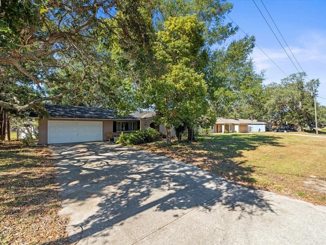 view of front of property with a front lawn and a garage