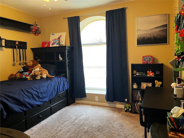 carpeted bedroom featuring a textured ceiling