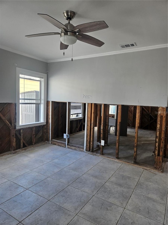 spare room featuring ceiling fan and ornamental molding