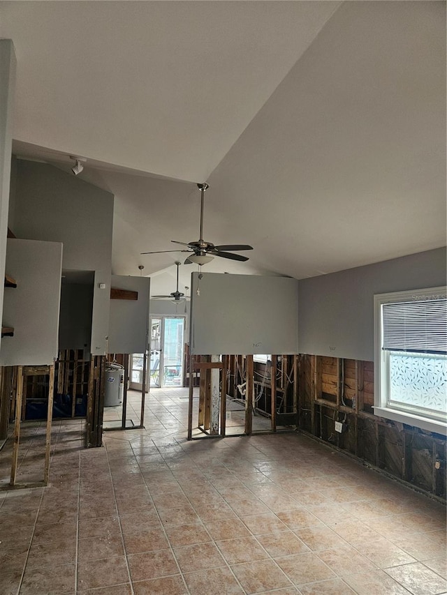 misc room featuring ceiling fan, a healthy amount of sunlight, light tile patterned floors, and high vaulted ceiling