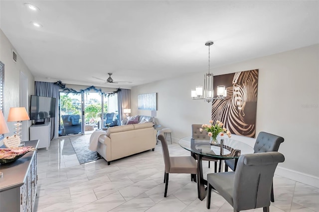 dining area with ceiling fan with notable chandelier