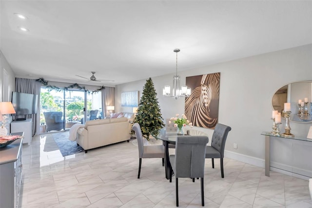 dining room with ceiling fan with notable chandelier