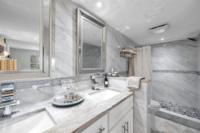 bathroom with vanity, a shower with shower curtain, tile walls, and toilet