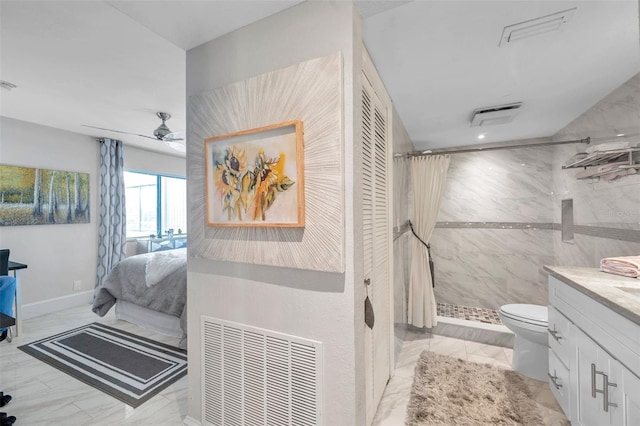 bathroom with vanity, ceiling fan, toilet, tile walls, and curtained shower