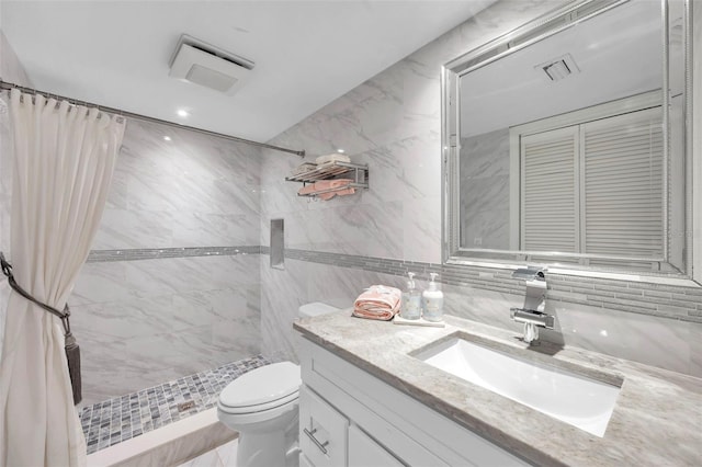 bathroom featuring vanity, toilet, tile walls, and curtained shower