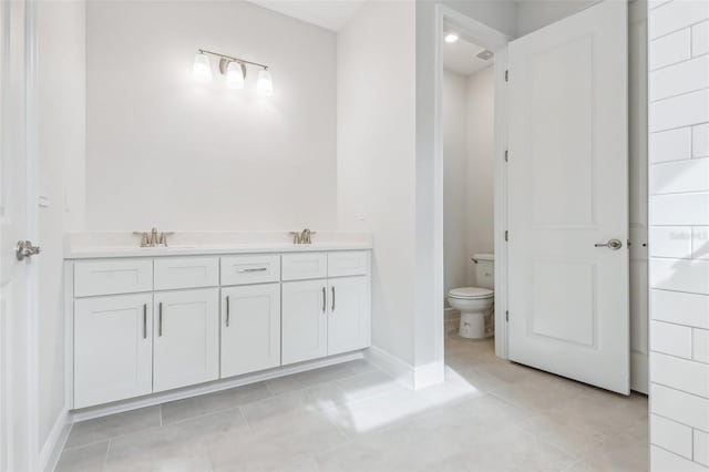 bathroom with tile patterned floors, vanity, and toilet