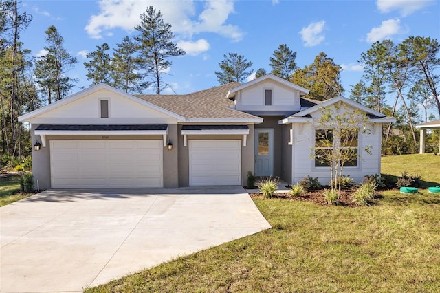 view of front of home featuring a front yard and a garage