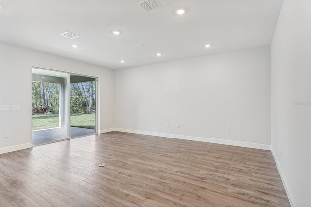 spare room with light hardwood / wood-style floors