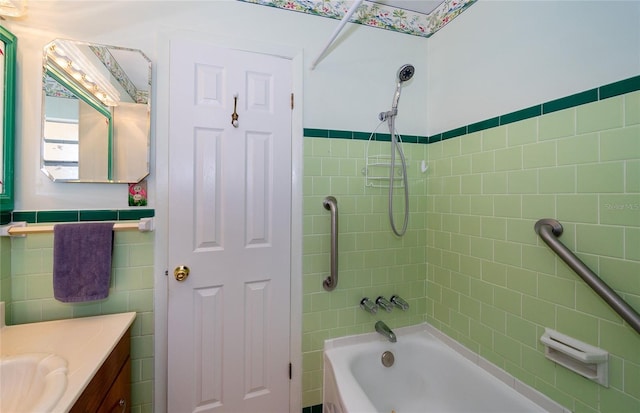 bathroom with vanity and tiled shower / bath combo