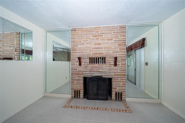 unfurnished living room with a fireplace and a textured ceiling