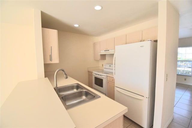 kitchen with white appliances, sink, and light tile patterned floors