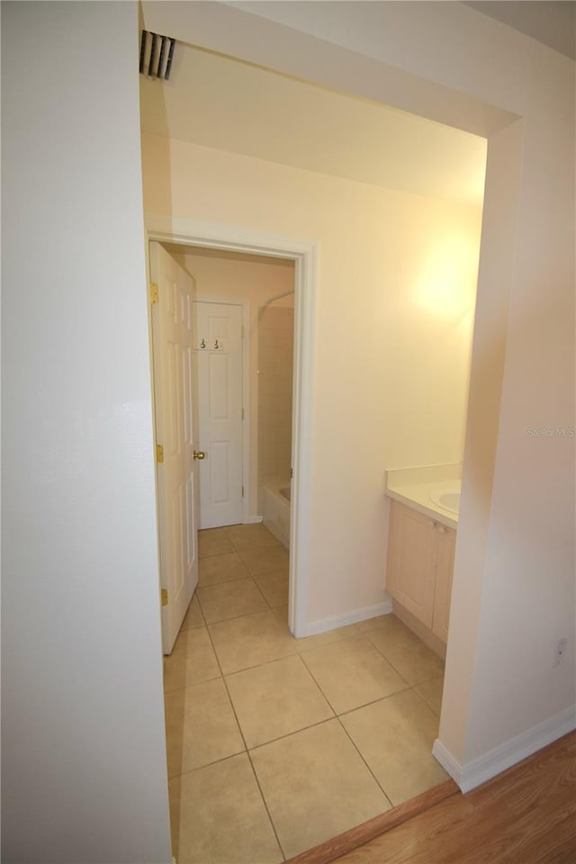 hallway featuring light tile patterned floors