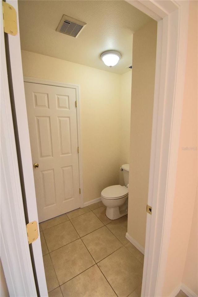 bathroom featuring tile patterned flooring and toilet