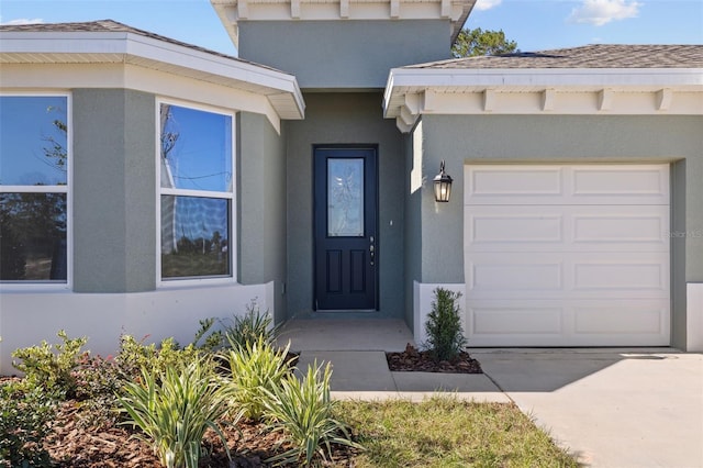 doorway to property with a garage