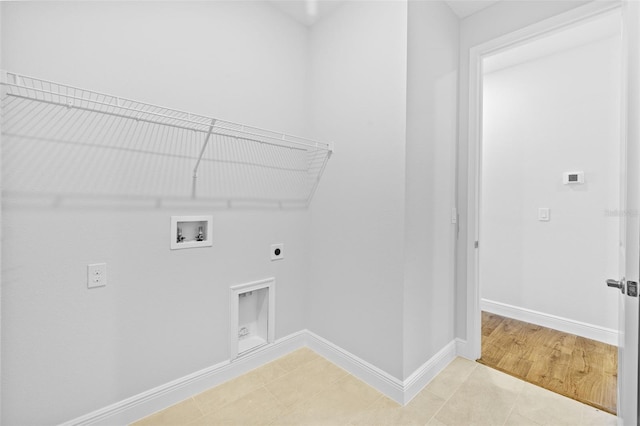 clothes washing area featuring light tile patterned flooring, washer hookup, and hookup for an electric dryer