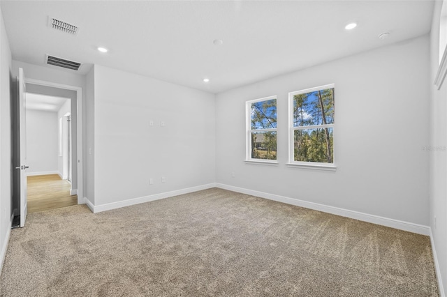 unfurnished room featuring light colored carpet