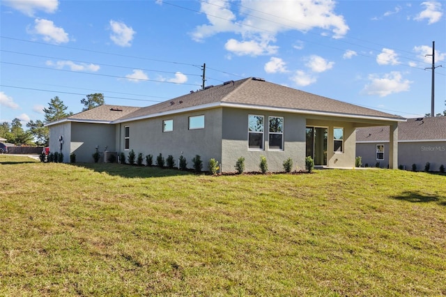 rear view of property featuring a yard