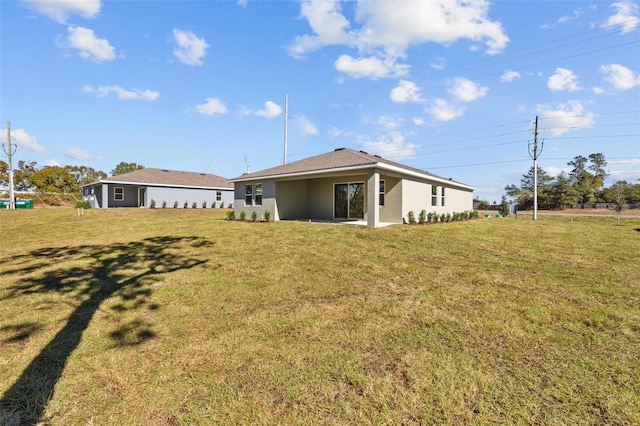 rear view of house with a lawn