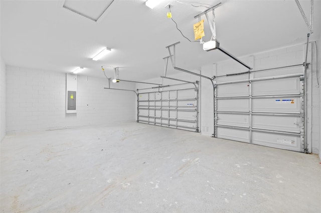 garage with electric panel and a garage door opener