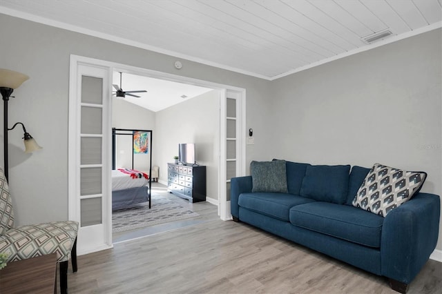 living room featuring ornamental molding, vaulted ceiling, wood ceiling, and light wood-type flooring