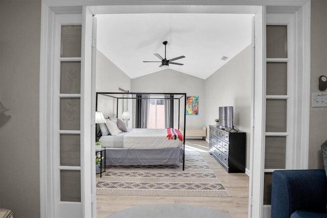 bedroom with lofted ceiling, ceiling fan, and light hardwood / wood-style flooring