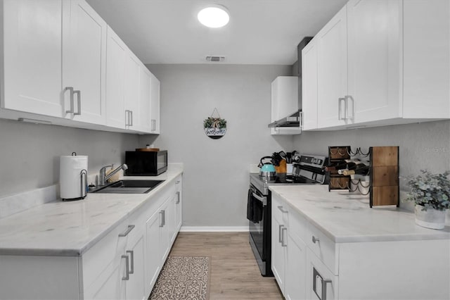 kitchen featuring sink, stainless steel electric range, light wood-type flooring, light stone countertops, and white cabinets