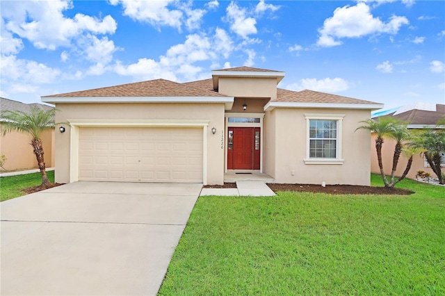 view of front of property featuring a front lawn and a garage