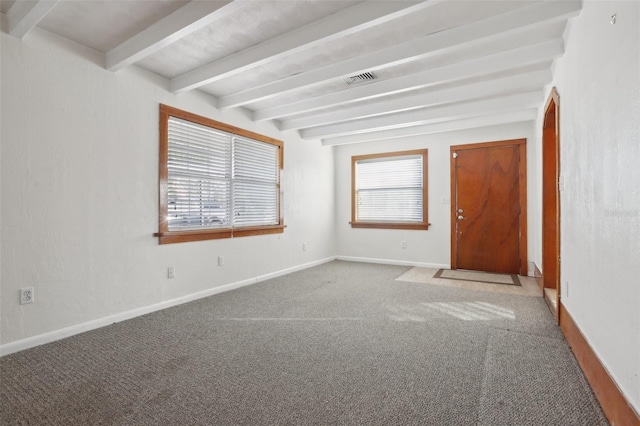 unfurnished room featuring carpet flooring and beamed ceiling