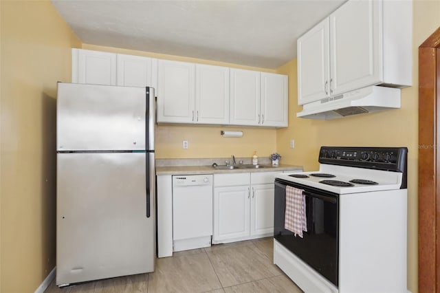 kitchen with white appliances, white cabinetry, and sink