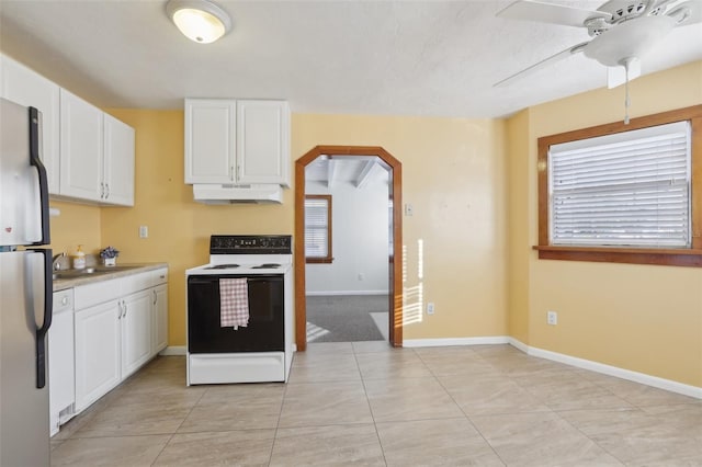 kitchen with stainless steel refrigerator, ceiling fan, sink, white range with electric cooktop, and white cabinets