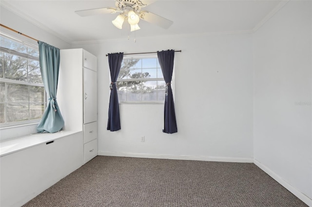 carpeted empty room with ceiling fan and crown molding