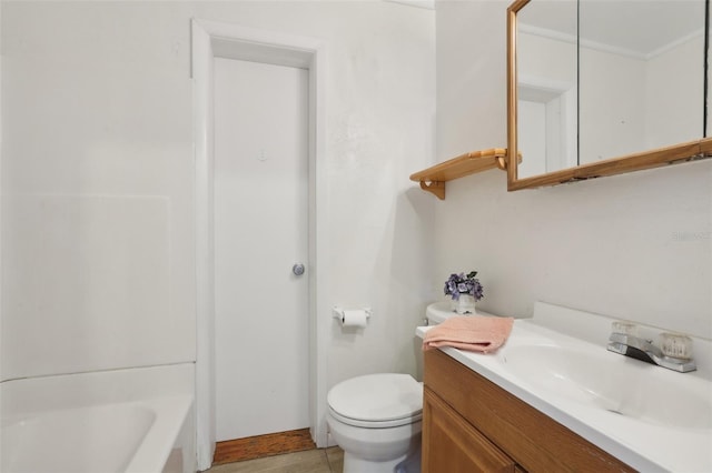 bathroom with tile patterned flooring, vanity, toilet, and a tub to relax in