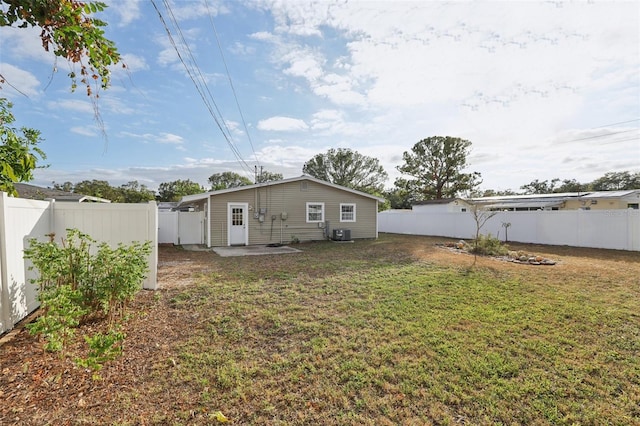 back of property featuring a lawn, cooling unit, and a patio