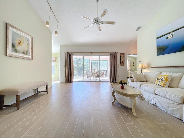 living room featuring high vaulted ceiling, a ceiling fan, visible vents, and light wood-style floors