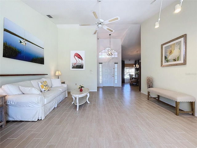 living room with high vaulted ceiling, a ceiling fan, baseboards, visible vents, and wood tiled floor