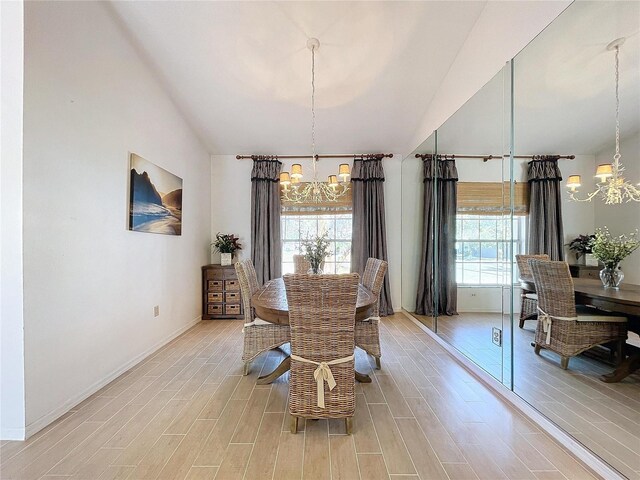 dining area with a chandelier, high vaulted ceiling, light wood-style flooring, and a healthy amount of sunlight