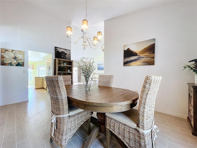 dining area featuring an inviting chandelier and baseboards