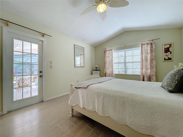 bedroom with lofted ceiling, ceiling fan, wood finished floors, and baseboards