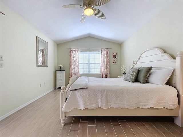 bedroom with a ceiling fan, lofted ceiling, baseboards, and wood finished floors