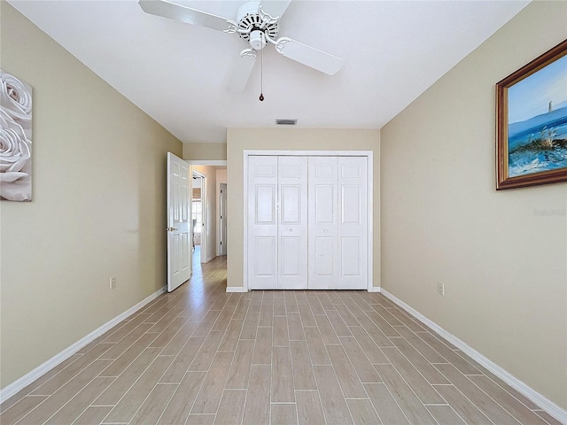 unfurnished bedroom with a ceiling fan, baseboards, visible vents, light wood-style floors, and a closet