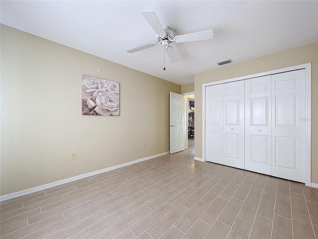 unfurnished bedroom featuring a closet, light wood-type flooring, visible vents, and baseboards