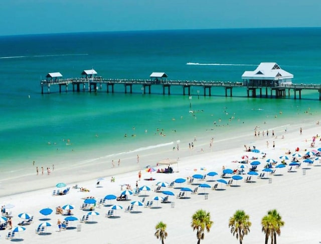 exterior space with a pier and a view of the beach