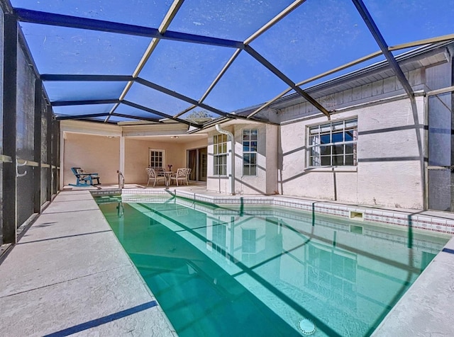 pool with a lanai and a patio