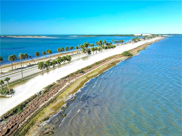 aerial view with a water view and a beach view