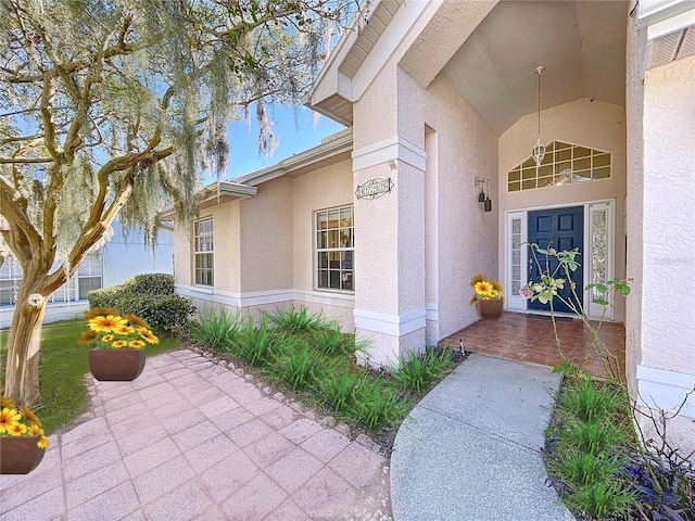 doorway to property featuring stucco siding