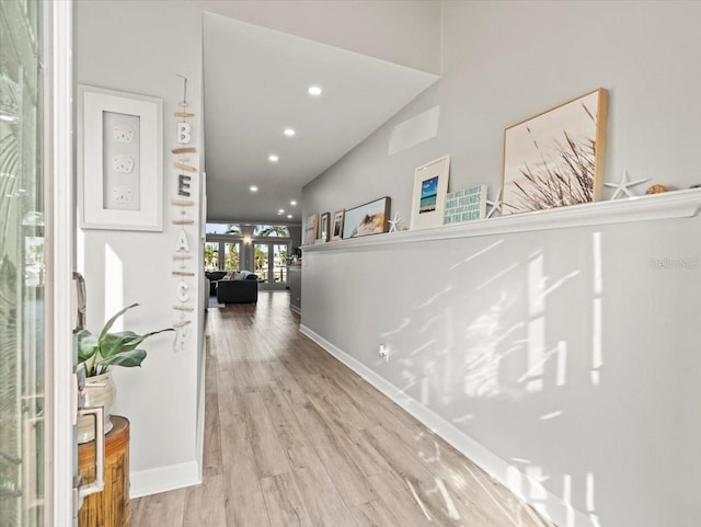 corridor featuring french doors and light hardwood / wood-style flooring