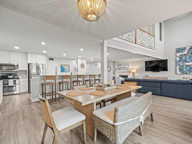 dining space with a chandelier and light wood-type flooring