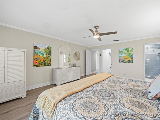 bedroom featuring connected bathroom, hardwood / wood-style flooring, ceiling fan, and crown molding