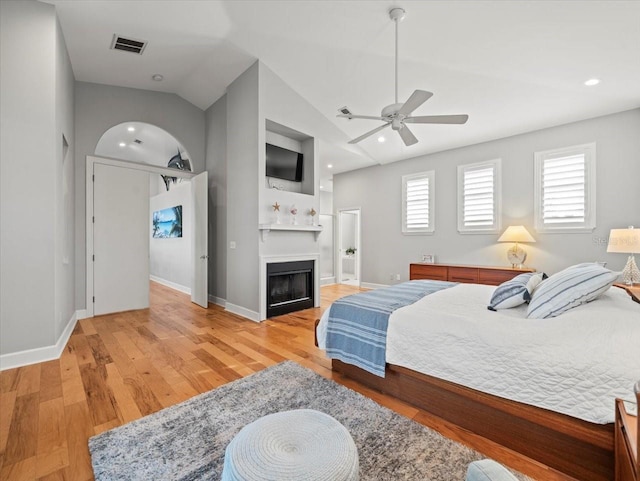 bedroom with hardwood / wood-style flooring, ceiling fan, and lofted ceiling