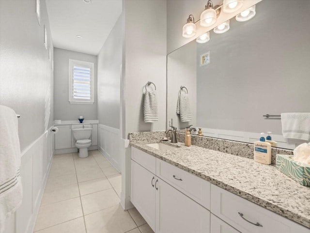 bathroom with tile patterned floors, vanity, and toilet